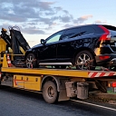 Evakuators pārvadā auto no ceļa uz tuvāko remonta darbnīcu.