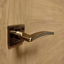 The door handle creaked