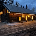 Log house in the evening with lighting