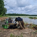 Pond cleaning from reeds and plant overgrowth with specialized equipment