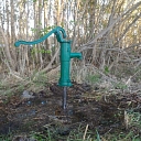 Hand water pump on spice well garden