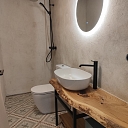 Bathroom interior with wooden elements and a designer sink