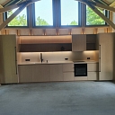 Wooden house kitchen area with individual design and lighting