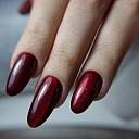 Dark red cat eye manicure