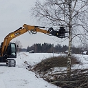 Chain excavator with pincer head services overgrown area, ditch, roadside, etc. for the provision of services