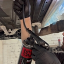 The CryoCar team protects the underside of cars with a high-quality rust prevention spray