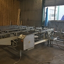 Automatic packaging line with feed into the filmer