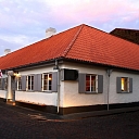 House with white walls and a red roof