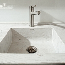 Washbasin with water grooves made of Corian ® material