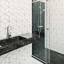 The surface of the bathroom with sink and shower remains with a panel made of Corian ® material