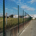 Welded fence on a concrete retaining wall