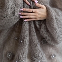 Soft sweater with elegant floral motifs.