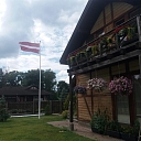 Latvian flag in the yard of a private house