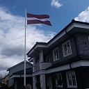 Latvian flag in the yard of a private house