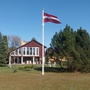 Latvian flag in the yard of a private house
