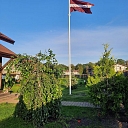 Latvian flag in the yard of a private house
