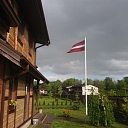 Latvian flag in the yard of a private house