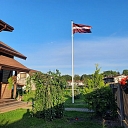 Latvian flag in the yard of a private house