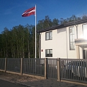 Latvian flag in the yard of a private house