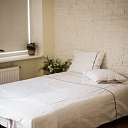 White linen bedding with decorative ribbon – natural comfort for the bedroom