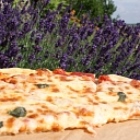 Pizza, cooked on an open fire in nature