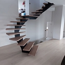 Curved metal staircase project with glass railings