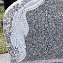 Granite monument with decorative leaf engraving