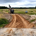 "Valmiera roads" an excavator works at a gravel road construction site in Vidzeme