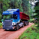 Scania truck transporting gravel on a forest road