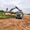 place of harvest, where a Volvo truck delivers the extracted materials for road construction