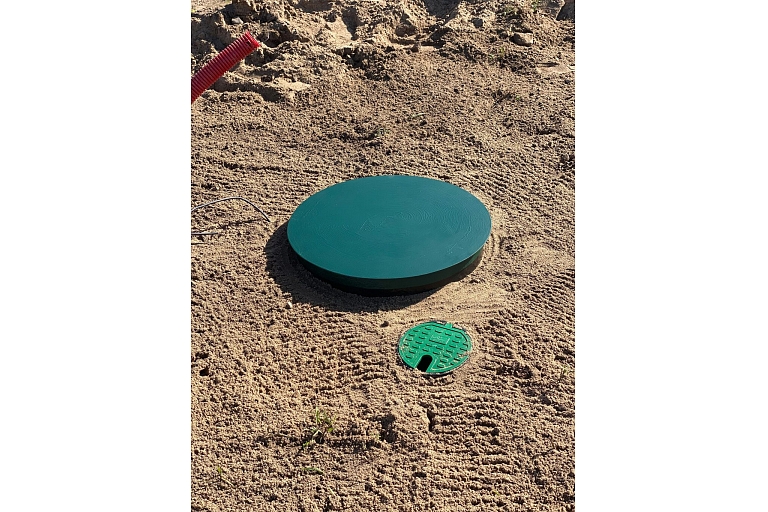 Water well with protective cover after installation