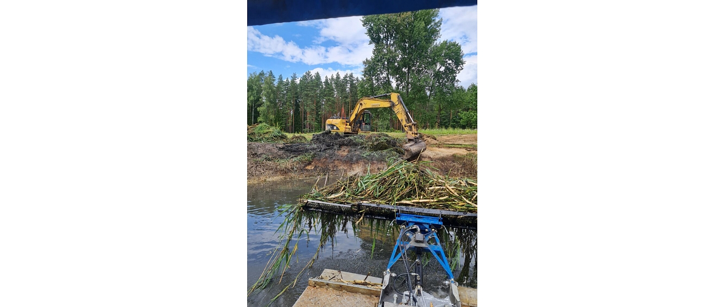 Cleaning a water body with an excavator
