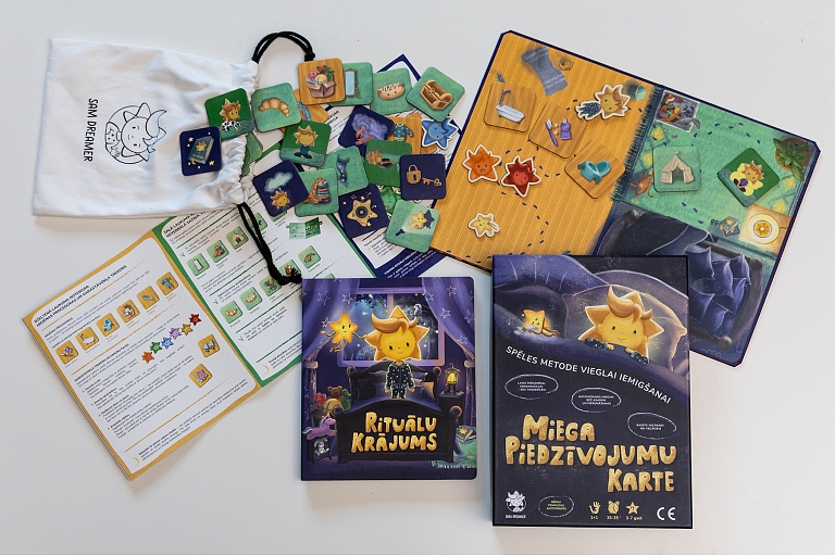 Sam Dreamer game components, including a book "Ritual Collection" and game board