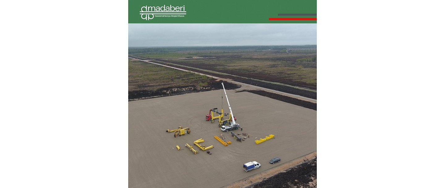 Construction work in a large area, where heavy equipment is deployed and the foundation is prepared for future projects.