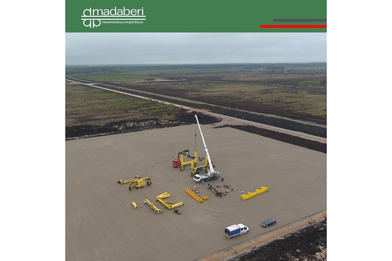 Construction work in a large area, where heavy equipment is deployed and the foundation is prepared for future projects.