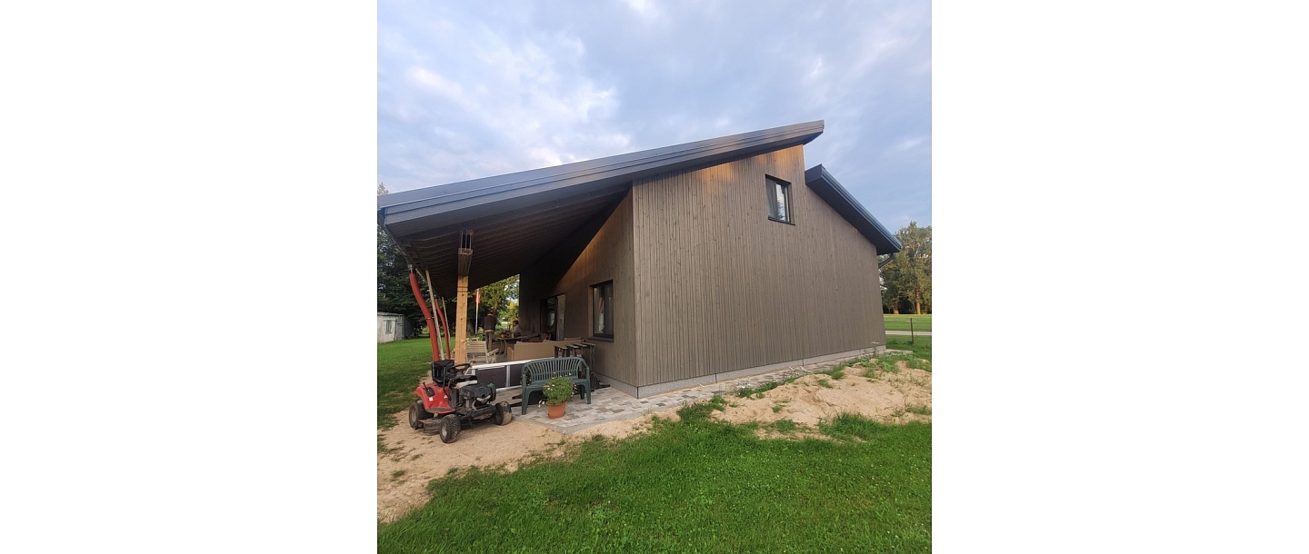 Wooden facade decoration and energy-efficient house construction