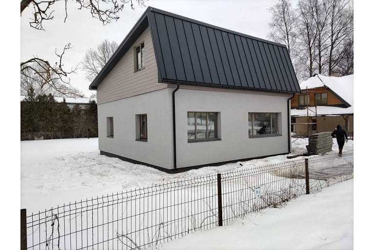 Private house with a metal roof in winter conditions