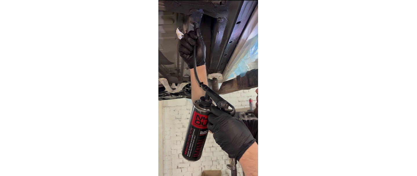 The CryoCar team protects the underside of cars with a high-quality rust prevention spray