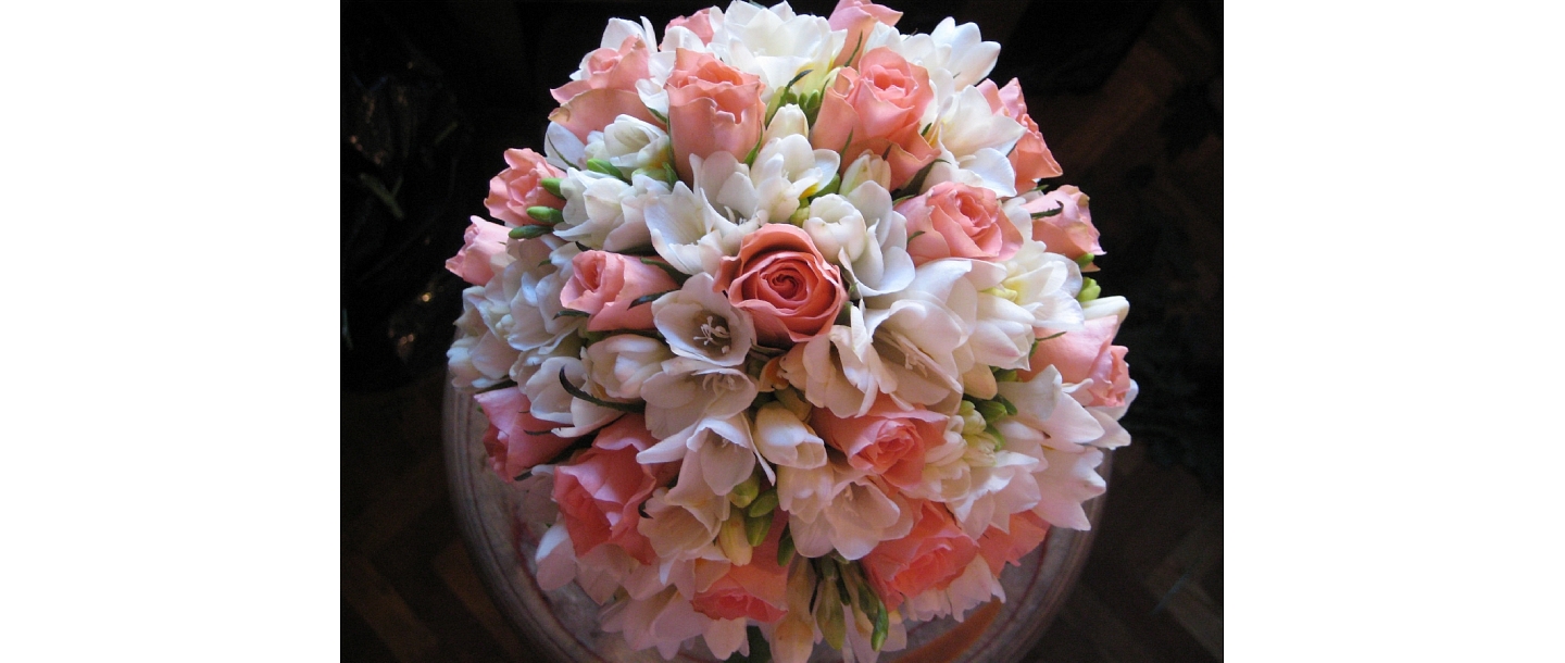 A bouquet of roses and freesias