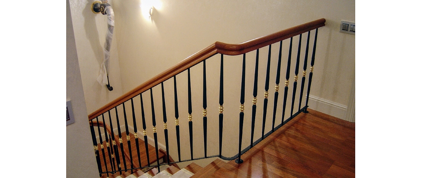 Classic stair railing with polished brass accents in a private house in Vecaki