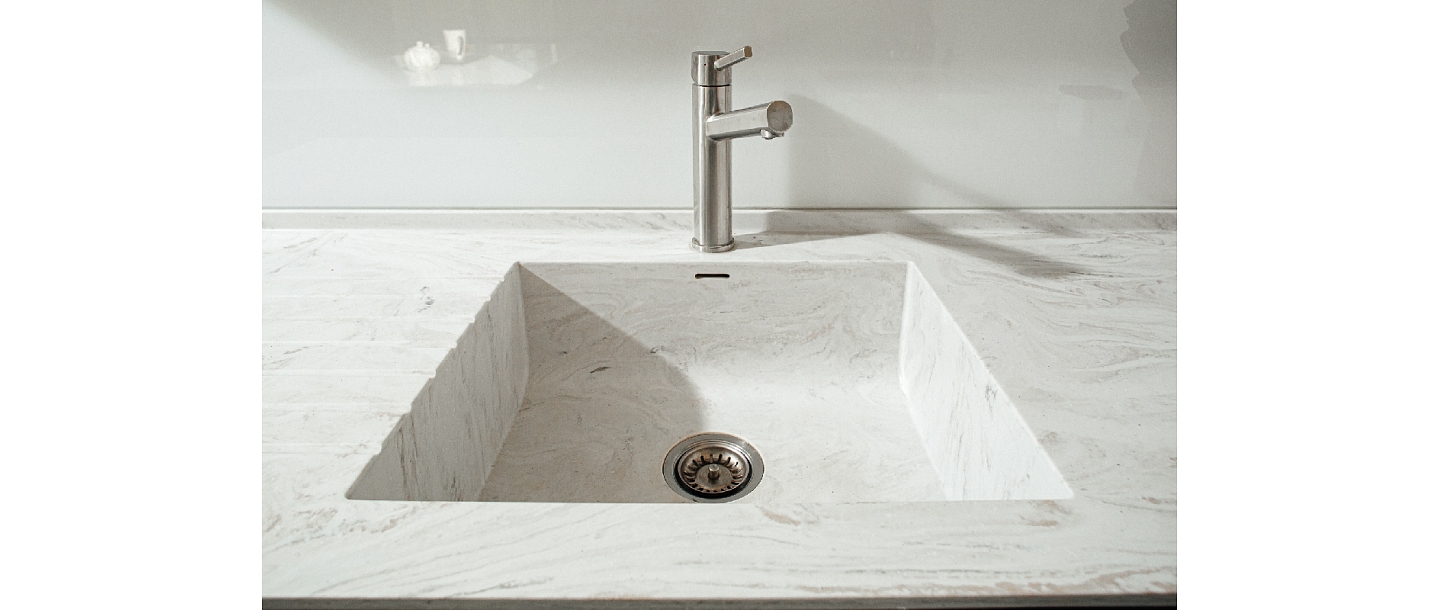 Washbasin with water grooves made of Corian ® material