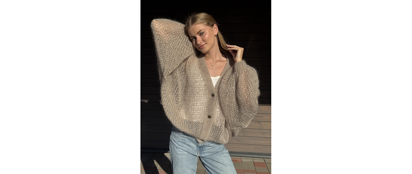 Soft, luxurious sweaters in various pastel colors.