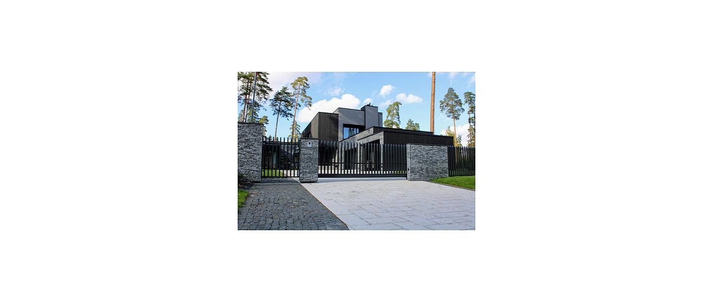 Custom metal fence installation near the house with a modern design