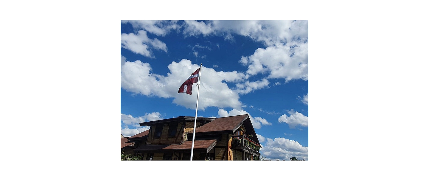 Latvian flag in the yard of a private house