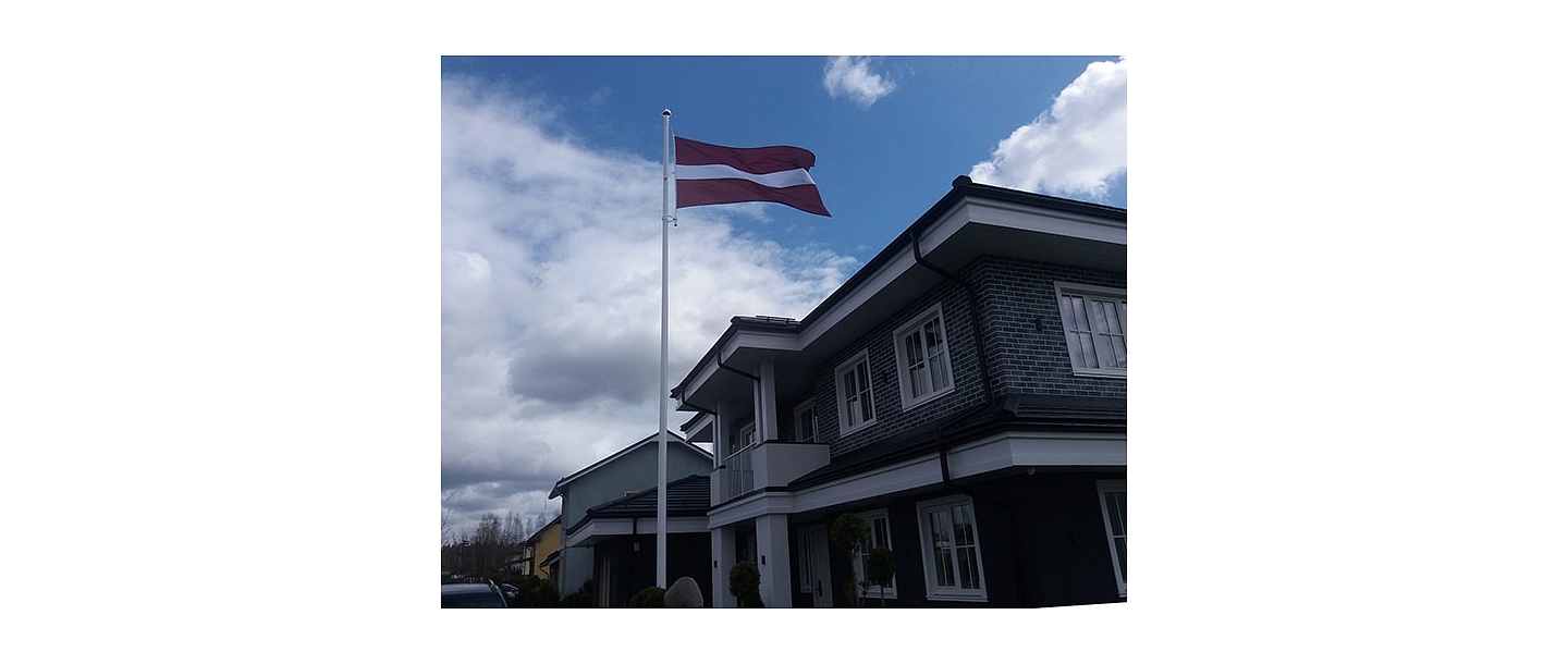 Latvian flag in the yard of a private house