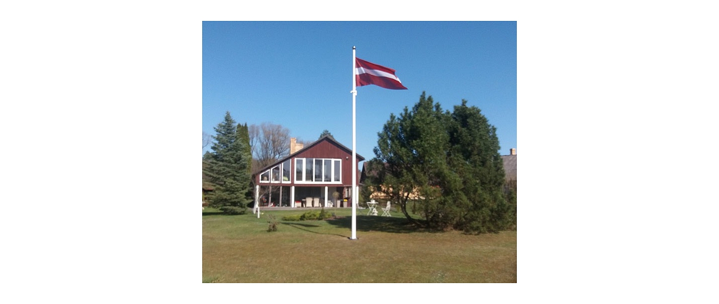 Latvian flag in the yard of a private house