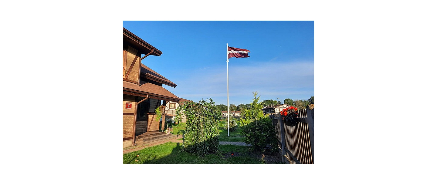 Latvian flag in the yard of a private house
