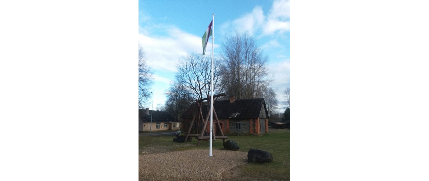 Latvian flag in the yard of a private house