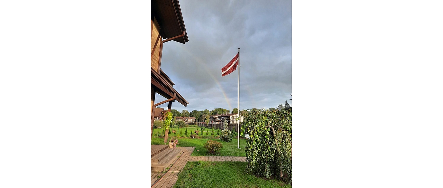 Latvian flag in the yard of a private house