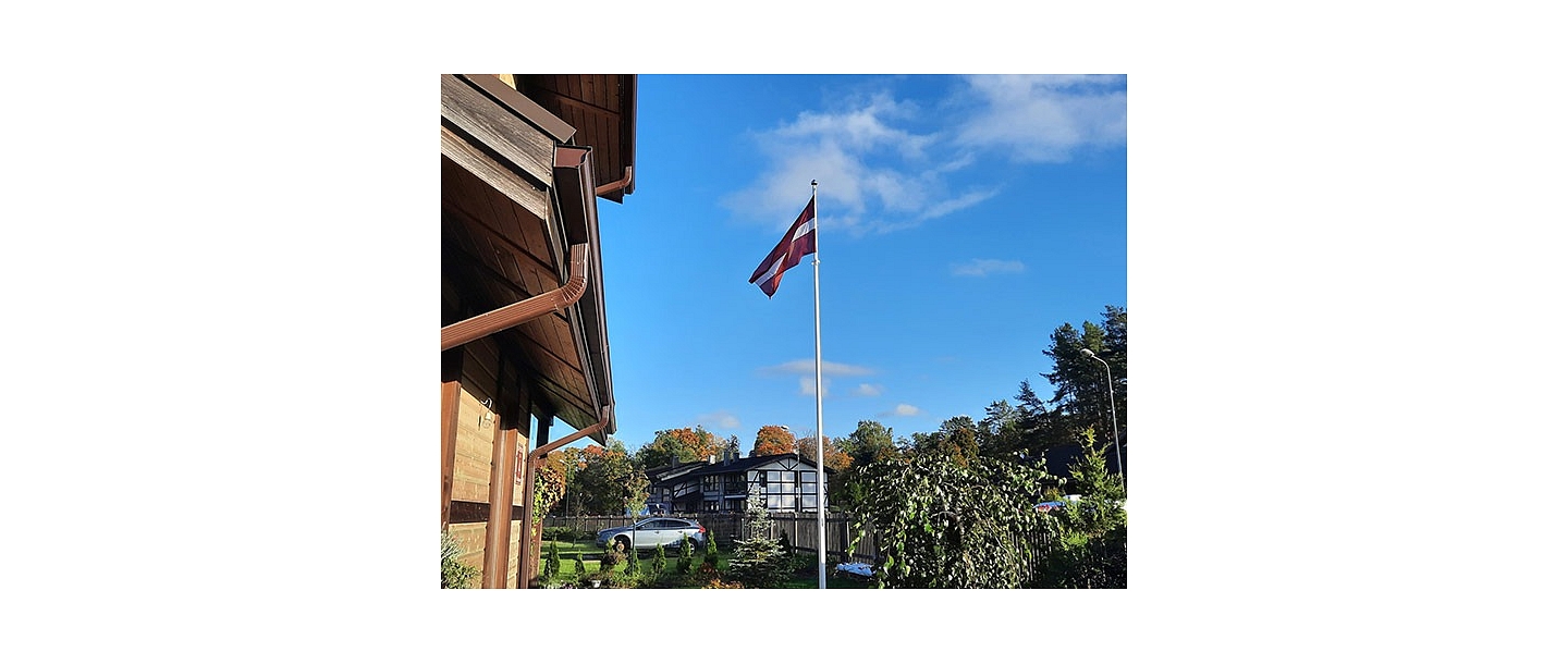 Latvian flag in the yard of a private house